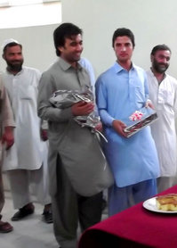 アフガン服のイサヌラさん（青い服）／ジャララバード事務所にて9月撮影