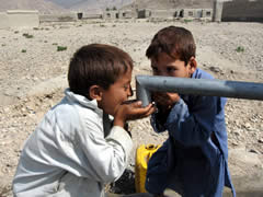 井戸水を飲む子どもたち