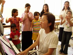 合唱する沢田さんと子供たち 