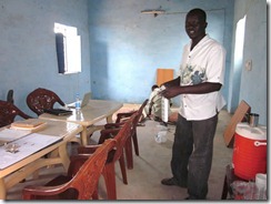 事務所内で電源取り付け作業をするスタッフのイサム。