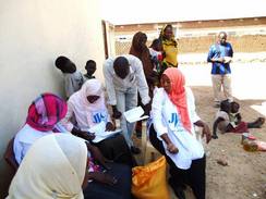 配布前に名簿をチェックするJVCスタッフとボランティア